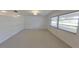Bright and airy living room with large windows and neutral carpet, providing a blank canvas for your style at 5337 11Th N Ave, St Petersburg, FL 33710