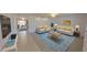 Open-concept living room featuring stylish furniture, a vibrant rug, and plenty of natural light at 5337 11Th N Ave, St Petersburg, FL 33710