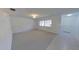 Bright living room features neutral carpet, white walls, and a large window for ample natural light at 5337 11Th N Ave, St Petersburg, FL 33710