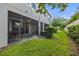 Home's backyard showcases a screened-in patio, landscaped lawn, and lush green shrubbery at 5813 Grand Sonata Ave, Lutz, FL 33558