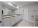 Elegant bathroom with double sinks, vanity, tile floor, and spacious shower area at 5813 Grand Sonata Ave, Lutz, FL 33558