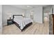 Relaxing bedroom featuring wood-look floors, neutral walls, and a comfortable bed at 5813 Grand Sonata Ave, Lutz, FL 33558