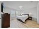 Comfortable bedroom with a ceiling fan, windows with blinds, and wood-look flooring at 5813 Grand Sonata Ave, Lutz, FL 33558