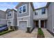 Well-maintained townhouses with garages, charming architectural details, and inviting front entrances at 5813 Grand Sonata Ave, Lutz, FL 33558