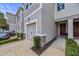 Attractive townhouse with a one-car garage, manicured landscaping, and a welcoming front entrance at 5813 Grand Sonata Ave, Lutz, FL 33558