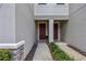 Home's front entrance features two separate doors and landscaped walkway at 5813 Grand Sonata Ave, Lutz, FL 33558