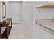 Inviting hallway featuring tile flooring, a console table, and a view of the front door at 5813 Grand Sonata Ave, Lutz, FL 33558