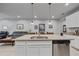Bright kitchen with white cabinets, stainless steel appliances, and a center island with seating at 5813 Grand Sonata Ave, Lutz, FL 33558