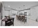 Open kitchen with white cabinets, stainless steel appliances, a center island, and dining area at 5813 Grand Sonata Ave, Lutz, FL 33558
