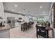 Open kitchen with white cabinets, stainless steel appliances, a center island, and dining area at 5813 Grand Sonata Ave, Lutz, FL 33558