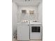 Bright laundry room with a washer and dryer and wire shelving for extra storage at 5813 Grand Sonata Ave, Lutz, FL 33558