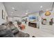 Bright living room with tile flooring, ceiling fan, stairs, and an open concept to the kitchen at 5813 Grand Sonata Ave, Lutz, FL 33558