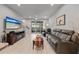 Bright living room with tile flooring, ceiling fan, sliding glass doors, and contemporary furnishings at 5813 Grand Sonata Ave, Lutz, FL 33558