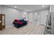Spacious living room with wood-look flooring, recessed lighting, and a comfortable blue sofa at 5813 Grand Sonata Ave, Lutz, FL 33558
