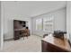 Bright home office space filled with vintage furniture and decor alongside light carpeting at 5813 Grand Sonata Ave, Lutz, FL 33558