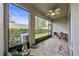 Charming screened patio with stone floors, offering a private outdoor space with views of the landscaped yard at 5813 Grand Sonata Ave, Lutz, FL 33558