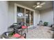 Relaxing covered patio featuring stone floors, ceiling fan, and comfortable seating, perfect for outdoor enjoyment at 5813 Grand Sonata Ave, Lutz, FL 33558