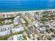 Picturesque aerial view of the neighborhood, showcasing nearby beach, charming homes, and lush greenery at 616 2Nd St, Indian Rocks Beach, FL 33785