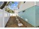 Backyard featuring white vinyl fence, well maintained landscaping, and partial sidewalk at 616 2Nd St, Indian Rocks Beach, FL 33785