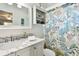 Bright bathroom with marble countertop and decorative shower curtain at 616 2Nd St, Indian Rocks Beach, FL 33785