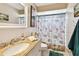 Bathroom featuring granite vanity with under mount sink and custom shower curtain at 616 2Nd St, Indian Rocks Beach, FL 33785