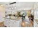 Open concept kitchen with granite island flowing into dining and living areas at 616 2Nd St, Indian Rocks Beach, FL 33785