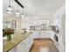 Bright kitchen with white cabinets, granite countertops, and stainless steel appliances at 616 2Nd St, Indian Rocks Beach, FL 33785