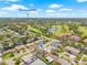 Scenic aerial view of the neighborhood with golf course, ponds, and a glimpse of Downtown St. Pete in the distance at 6400 Mockingbird S Way, St Petersburg, FL 33707