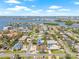 Picturesque aerial view of the neighborhood with water views, sandy beaches, and a vibrant coastal atmosphere in the distance at 6400 Mockingbird S Way, St Petersburg, FL 33707