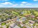 Scenic aerial view of the neighborhood with golf course, ponds, and a glimpse of Downtown St. Pete in the distance at 6400 Mockingbird S Way, St Petersburg, FL 33707