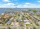 Picturesque aerial view of the neighborhood with water views, sandy beaches, and a vibrant coastal atmosphere in the distance at 6400 Mockingbird S Way, St Petersburg, FL 33707