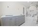 Bathroom featuring double vanity and marble tile surround in the shower and tub area at 6400 Mockingbird S Way, St Petersburg, FL 33707