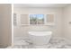 Freestanding tub with a view of the backyard at 6400 Mockingbird S Way, St Petersburg, FL 33707