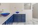 Bathroom featuring double vessel sinks, quartz countertops, and a shower with a tiled backsplash at 6400 Mockingbird S Way, St Petersburg, FL 33707