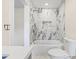 Bathroom featuring marble tile surround in the shower and tub area at 6400 Mockingbird S Way, St Petersburg, FL 33707