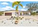 Inviting one-story house with well-manicured landscaping and a circular driveway at 6400 Mockingbird S Way, St Petersburg, FL 33707