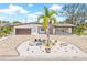 Well-maintained home featuring a circular driveway with a palm tree and manicured landscaping at 6400 Mockingbird S Way, St Petersburg, FL 33707