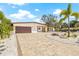 Charming single-story home featuring a meticulously landscaped front yard and brick driveway at 6400 Mockingbird S Way, St Petersburg, FL 33707