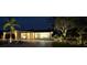 Beautiful home with brick accents, lush landscaping, and a charming front entrance illuminated by outdoor lighting at 6400 Mockingbird S Way, St Petersburg, FL 33707