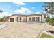 Charming single-story home featuring a meticulously landscaped front yard and brick driveway at 6400 Mockingbird S Way, St Petersburg, FL 33707