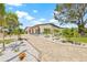 Beautifully landscaped front exterior with an expansive driveway and lush greenery at 6400 Mockingbird S Way, St Petersburg, FL 33707
