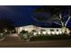 Lovely home with mature trees, updated landscaping and manicured lawn illuminated by landscape lighting at 6400 Mockingbird S Way, St Petersburg, FL 33707