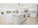 Bright kitchen with island, modern appliances, and open concept to living area at 6400 Mockingbird S Way, St Petersburg, FL 33707