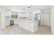 Bright white kitchen featuring stainless steel appliances and marble countertops at 6400 Mockingbird S Way, St Petersburg, FL 33707