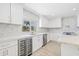 Bright kitchen featuring white cabinets, stainless appliances, and a wine fridge at 6400 Mockingbird S Way, St Petersburg, FL 33707