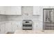 Bright kitchen featuring white cabinets, stainless appliances, and marble countertops at 6400 Mockingbird S Way, St Petersburg, FL 33707