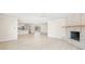 Spacious living room featuring a charming fireplace open to the kitchen and backyard at 6400 Mockingbird S Way, St Petersburg, FL 33707