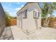 Exterior view of a charming shed with an AC unit, nestled on a bright white gravel ground and surrounded by lush palms at 6400 Mockingbird S Way, St Petersburg, FL 33707