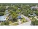 Aerial view of a single-Gathering home in a neighborhood surrounded by lush greenery and mature trees at 6401 N Central Ave, Tampa, FL 33604