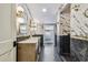 Modern bathroom with marble walls, dual vanities, and sleek fixtures at 6401 N Central Ave, Tampa, FL 33604